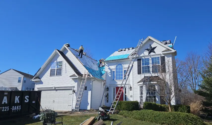 Roof Repair on two story White Home